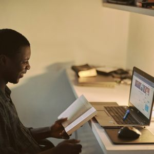 man in black dress shirt using laptop computer